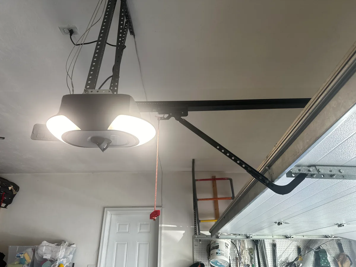 Modern residential garage door opener with LED light installed on ceiling